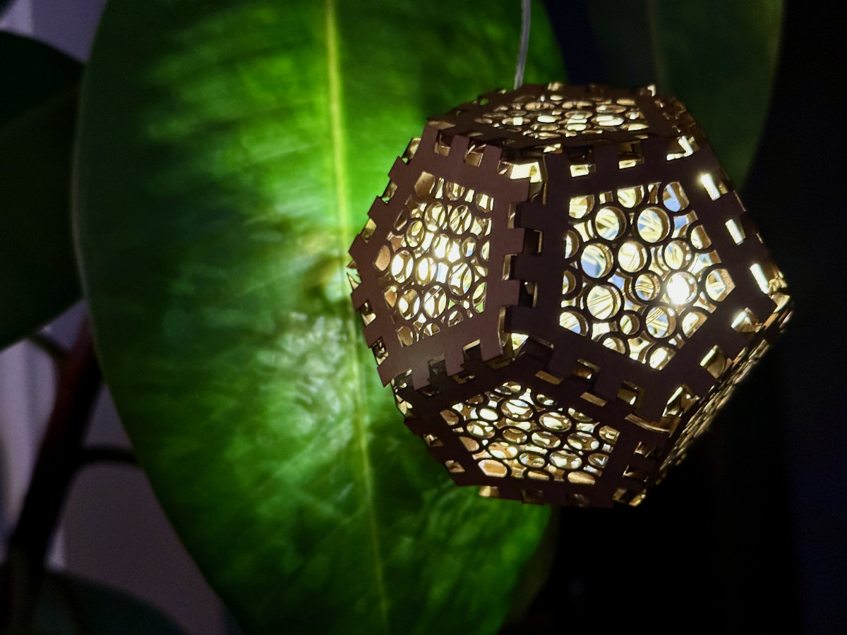 A small decorative lamp made from recycled cardboard.