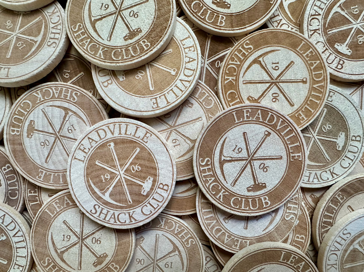 Custom engraved wooden tokens (or nickels) for a local social club.
